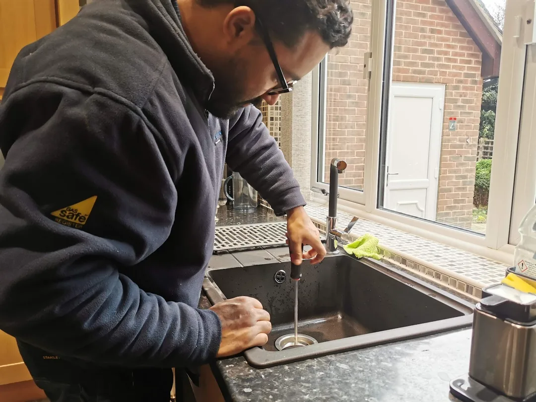 Engineer working on a kitchen sink, from Supreme Plumbers’ Google Business Profile